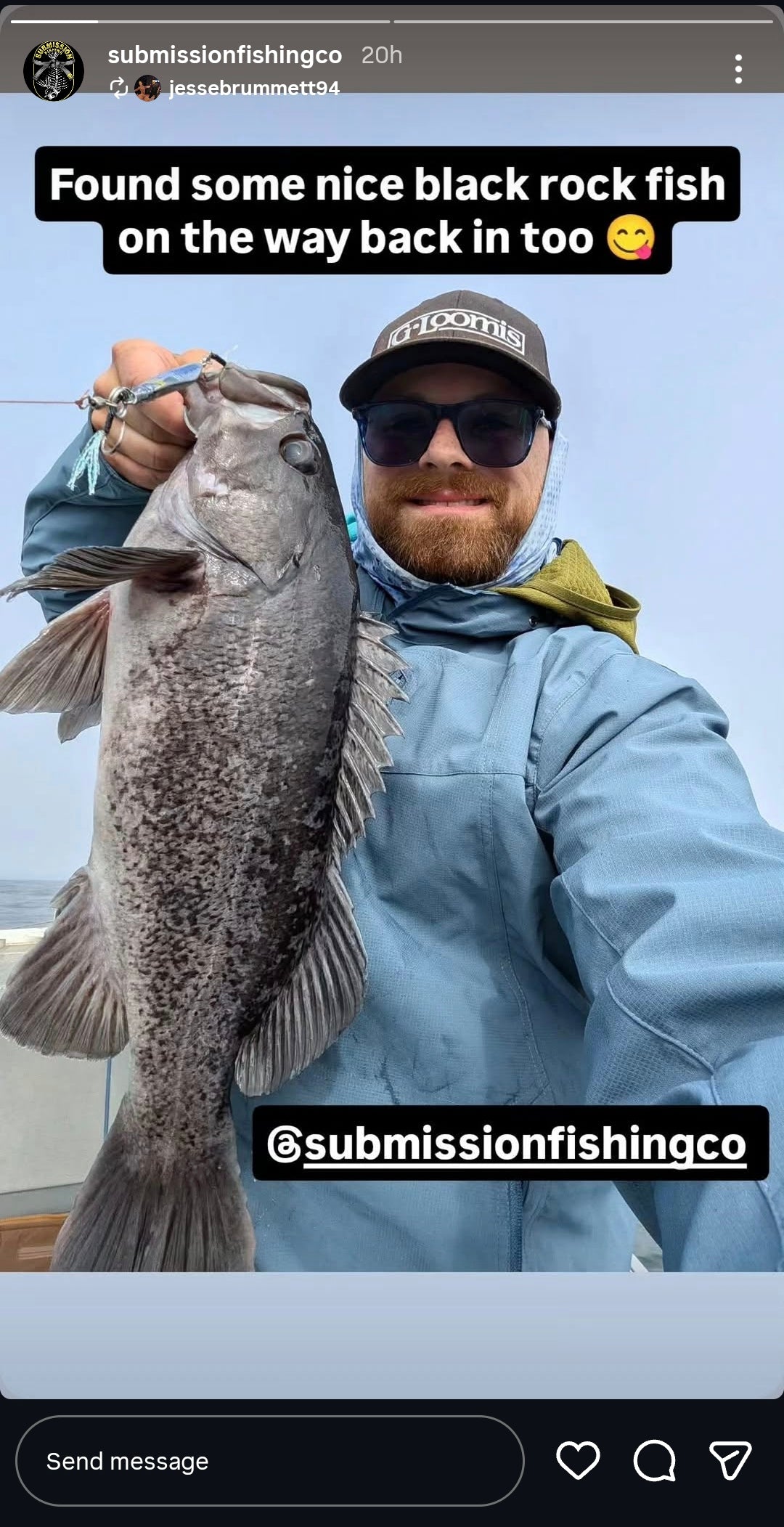 A man wearing a blue hooded jacket, sunglasses, and a cap holds up a large black rock fish in a selfie-style photo. The image includes social media text overlays reading 'Found some nice black rock fish on the way back in too' and '@submissionfishingco'.