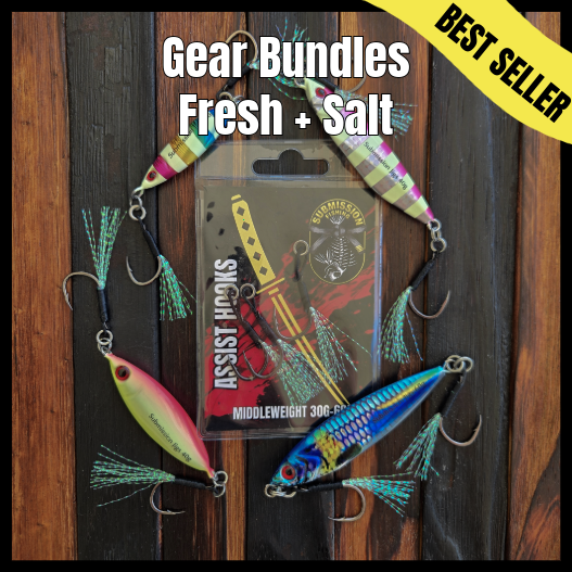 Assorted fishing lures with a package labeled 'Assist Hooks' on a wooden background.