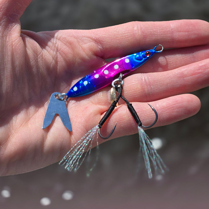 Rotten Candy Death Blade 15g slow pitch fishing jig with assist hook shown in hand for size comparison
